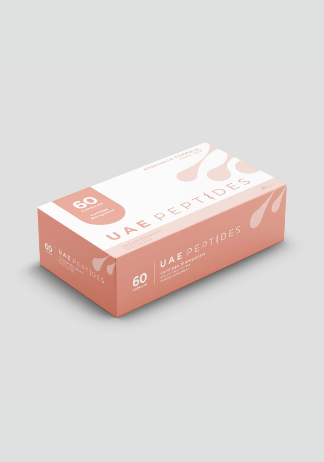Side image of one box of Dnhealth peptide supplements displayed against a light grey background. The color of the box is white and pink and is labelled as a Cartilage Bioregulator.