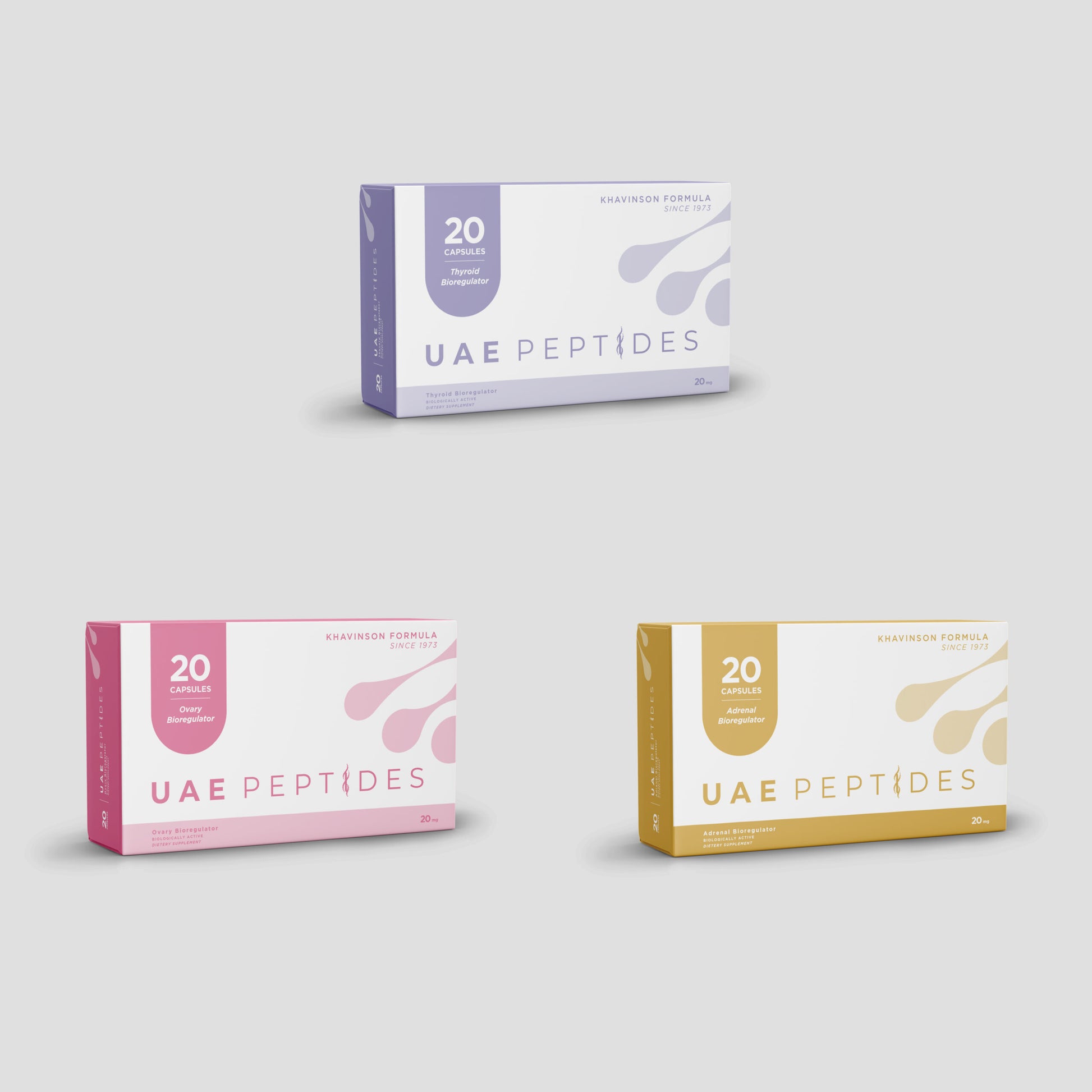 Front image of three boxes of Dnhealth peptide supplements are displayed against a light grey background. The top box is white and lavender and is labelled as a Thyroid Bioregulator. The bottom left box is white and pink and is labelled as an Ovary Bioregulator. The bottom right box is white and gold and is labelled as an Adrenal Bioregulator.